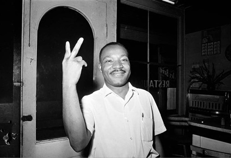Martin Luther King Jr flashes a peace sign in st augustine after learning civil rights act passed
